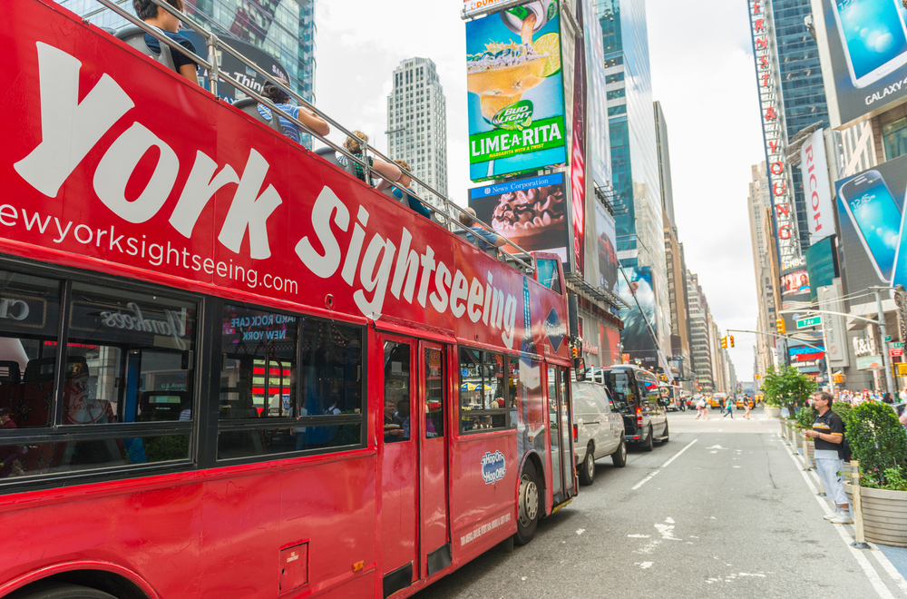 red new york city sightseeing bus on the street