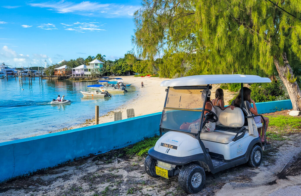 Golf cart parked in front of a beach