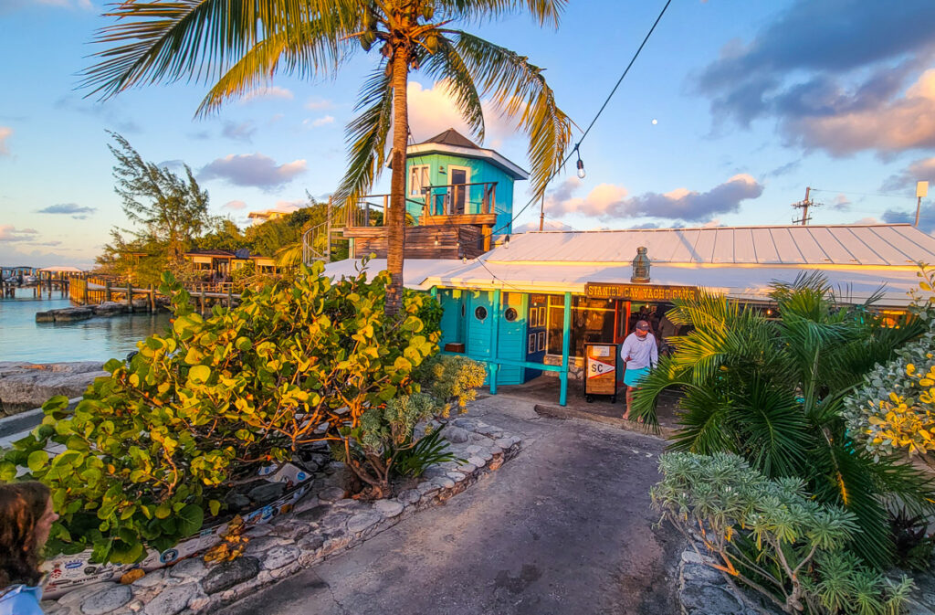 Entrance to a restaurant on an island with palm trees blowing