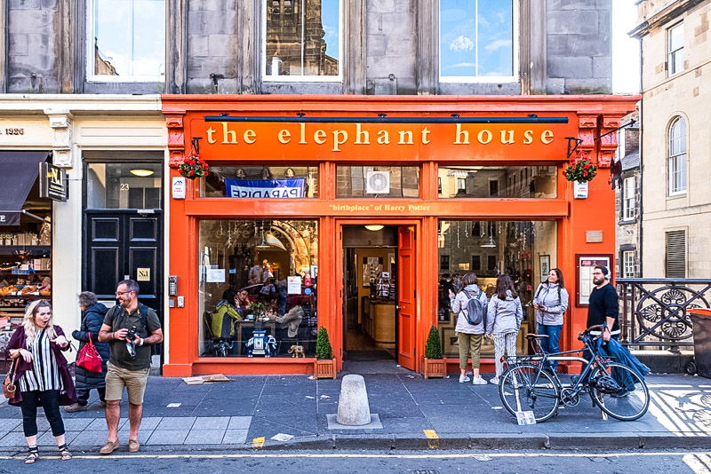 People standing outside the orange facade of the elephant house