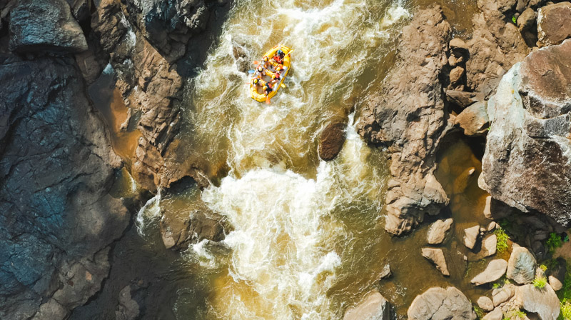Aerial view of a Raging Thunder raft on the white water rapids