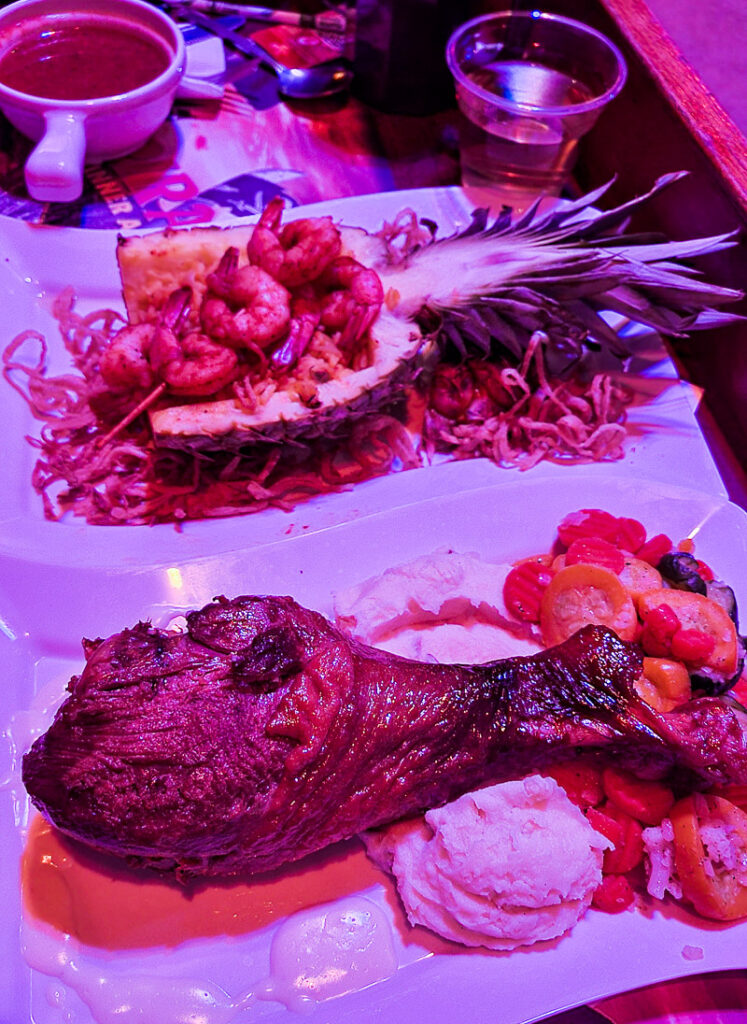 Turkey leg and shrimp on a dinner plate