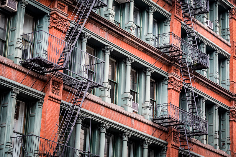 fire escapes on outside of red brick buildings in soho nyc