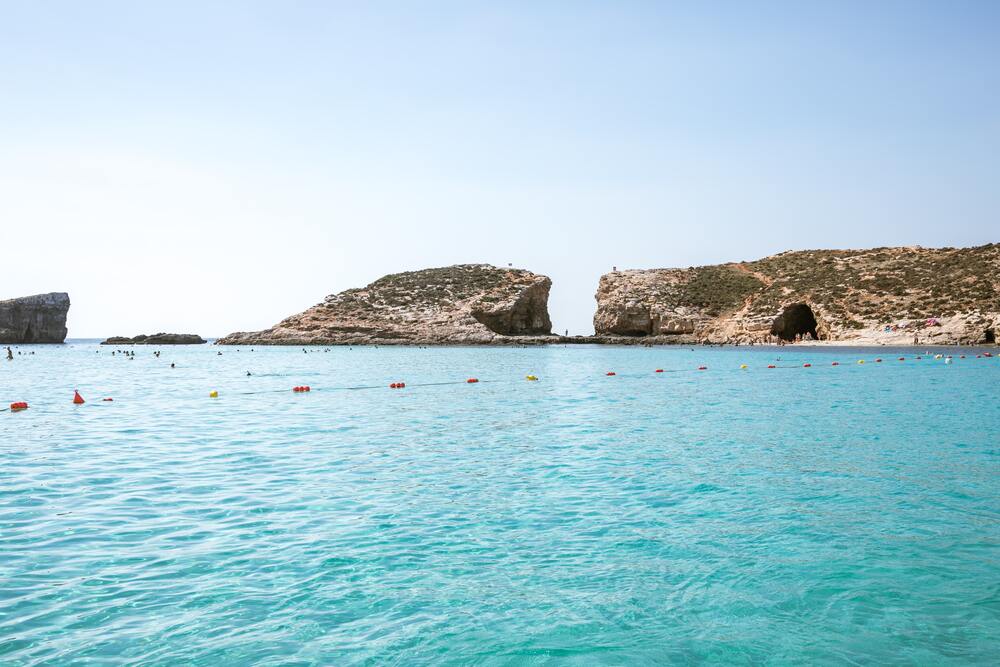 blue waters and coastline of comino