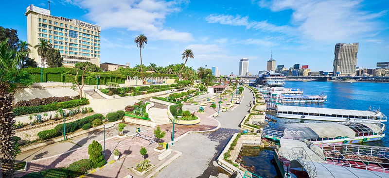 The riverside promenade on Gezira island with cozy ornamental garden, pleasure boats in tourist port and picturesque views 