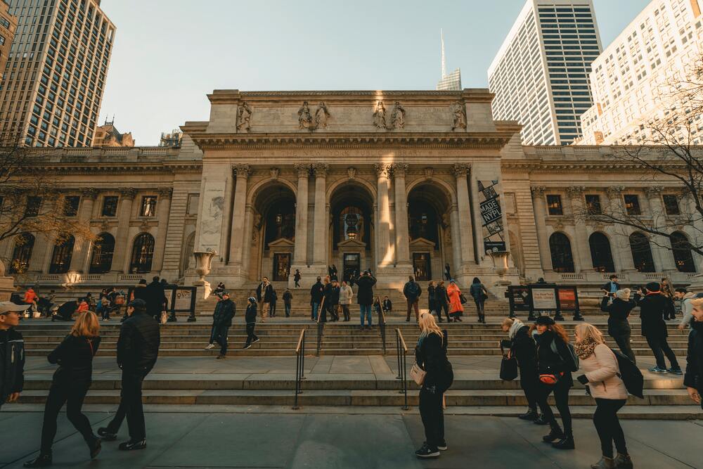 people walking outside new york library