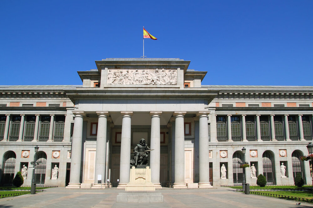 Outside of prado museum with columned foyer and statues