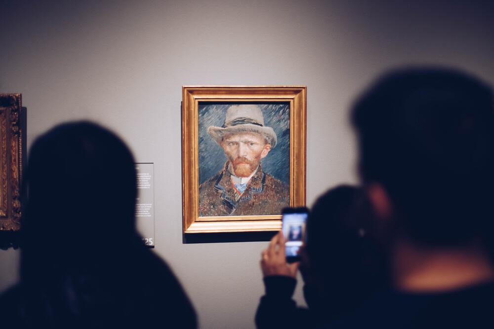 people looking at Vincent Van Gogh portrait