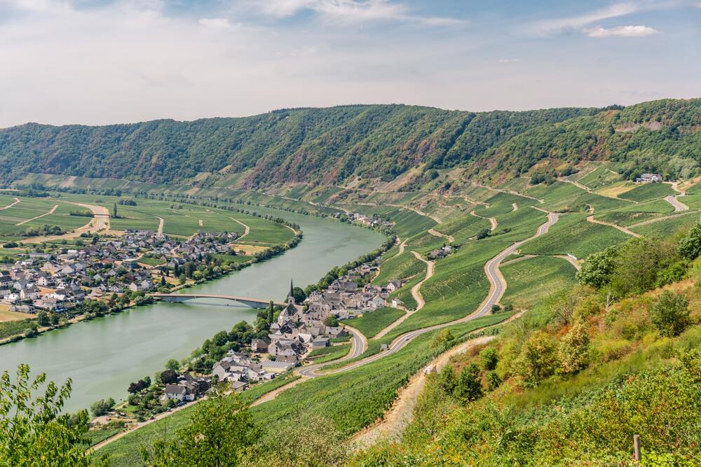 river mosel running through the valley past a village