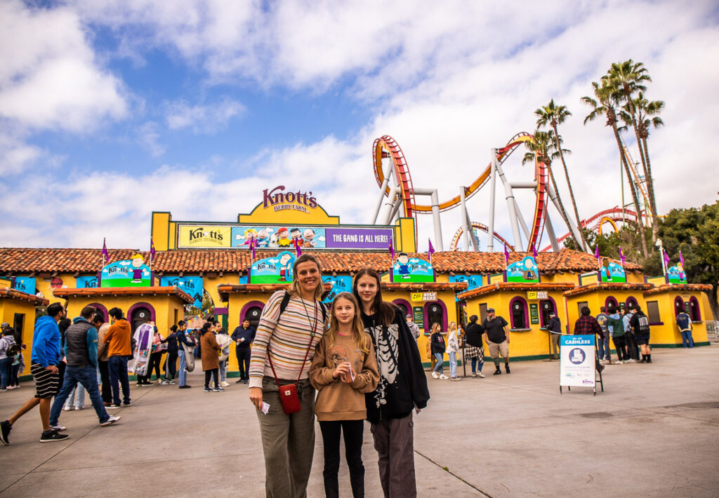 Mom and daughter standing at front entrance to a theme park called Knott's Berry Farm