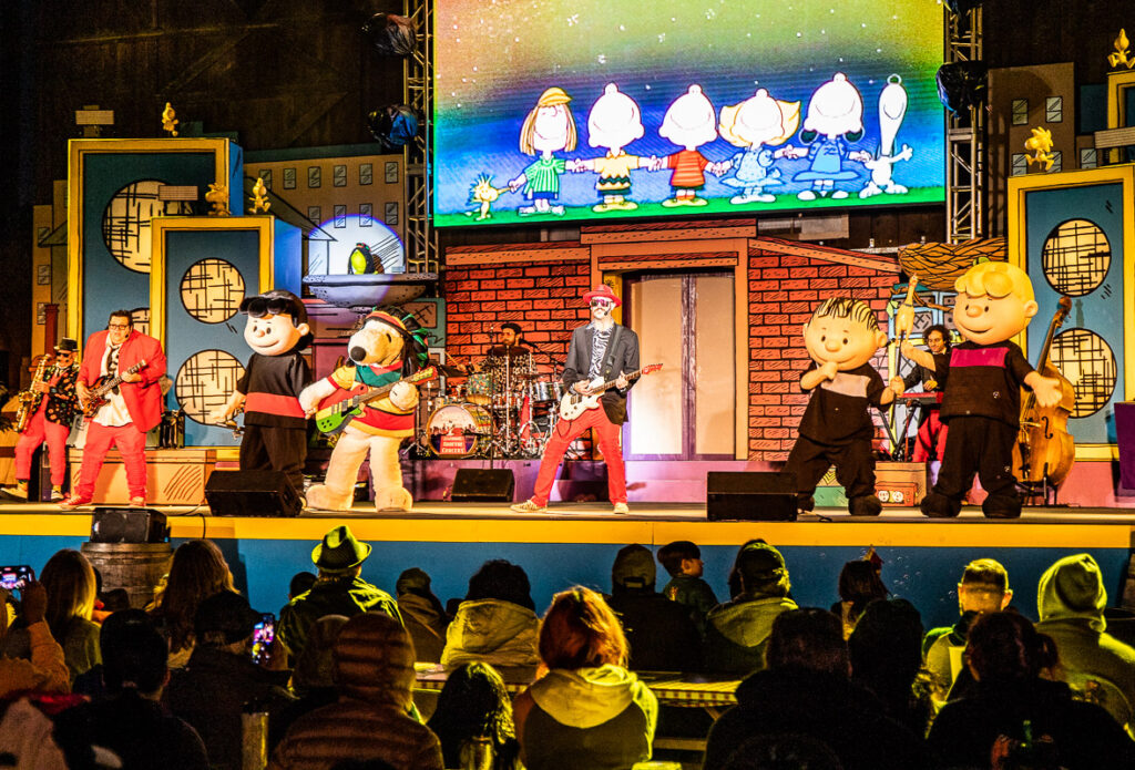 Characters singing on stage at a theme park