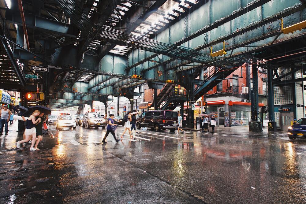 people crossing street on rainy day in williamsburg