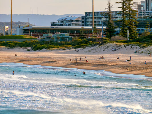 People enjoying the sand and surf at Main Beach, Wollongong.