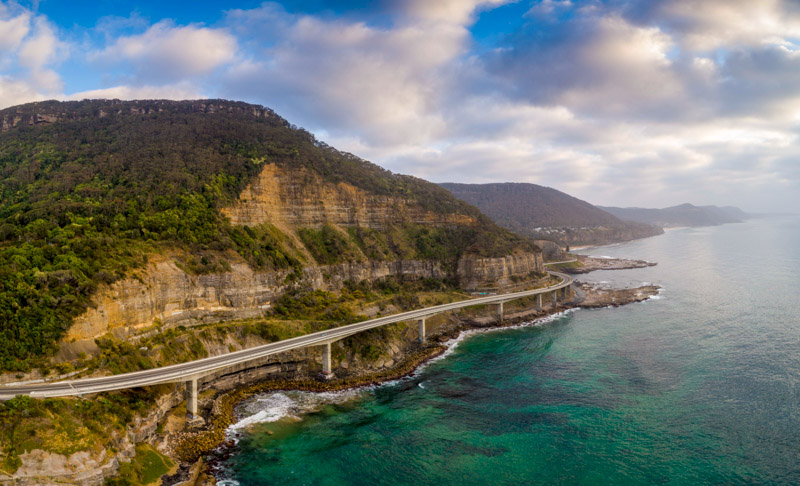 Aerial overlooking the scenic Sea Cliff Bridge in Clifton.