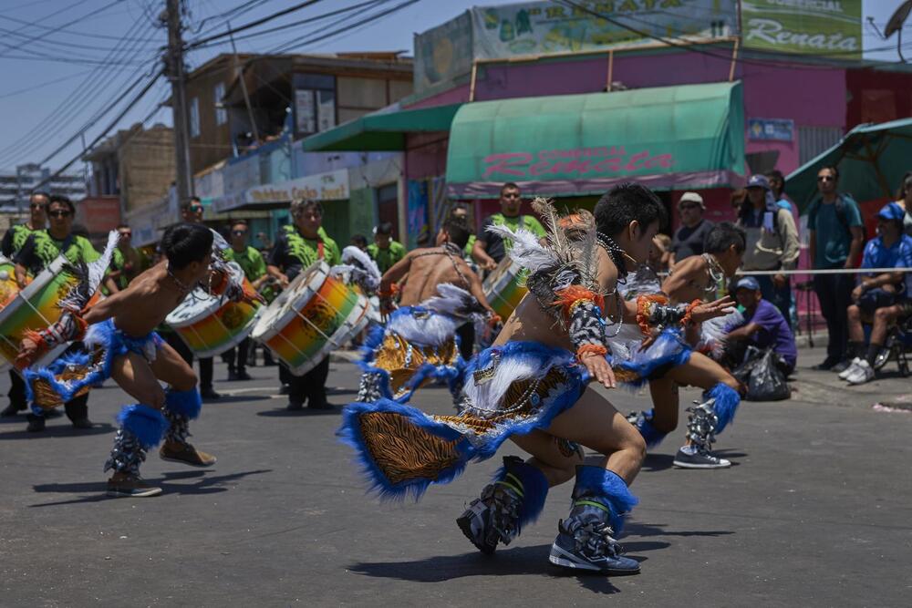 men dressed in costumes dancing on street