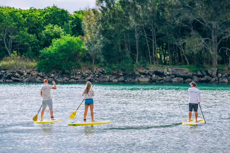 Couple enjoying a stand up paddleboarding experience with SWR SUP along Back Creek, South West Rocks.