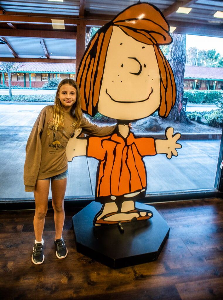 girl standing next to character cut out 