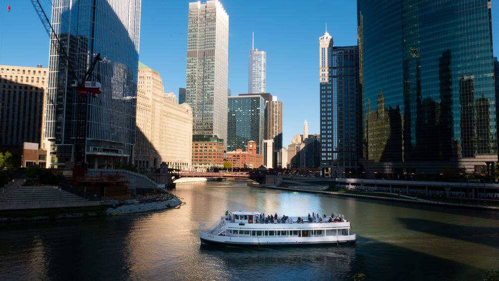 boat crusing down chicago river 