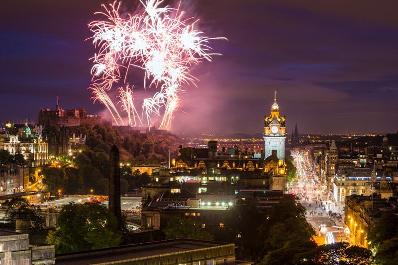 Edinburgh Cityscape with fireworks over The Castle and Balmoral Clock Tower