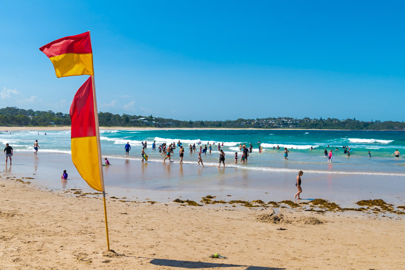 People enjoying the sunny weather at Mollymook Beach, 