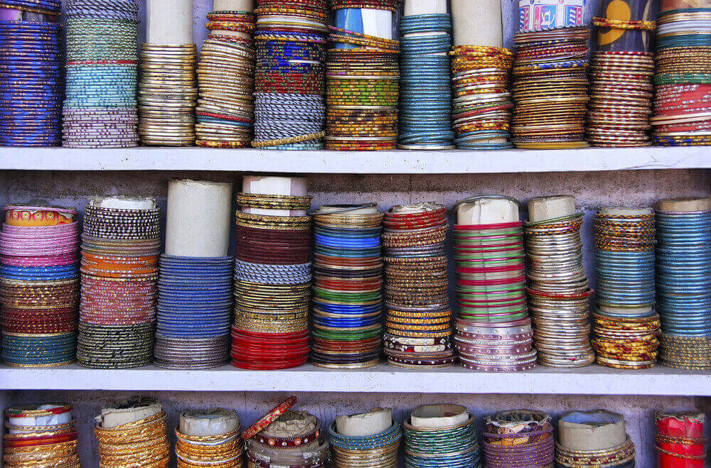 rows of colorful beaded bracelets on store shelves