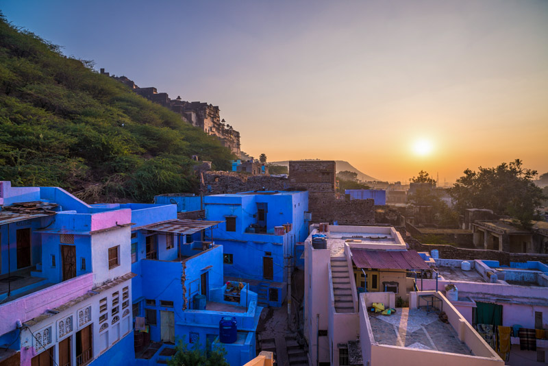 Bundi cityscape at sunset. The majestic city palace perched on mountain slope, travel destination in Rajasthan, India
