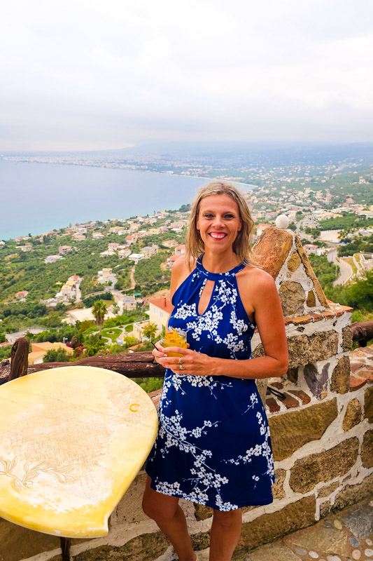 caz posing with view of kalamata coastline behind her
