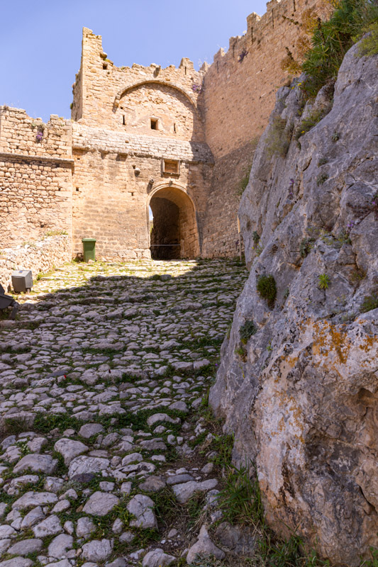 cobblestone path leading up to the old gates of acrocorinth