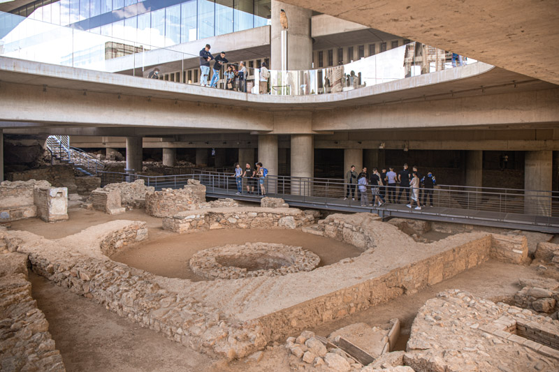 people looking at excavations under acropolis museum