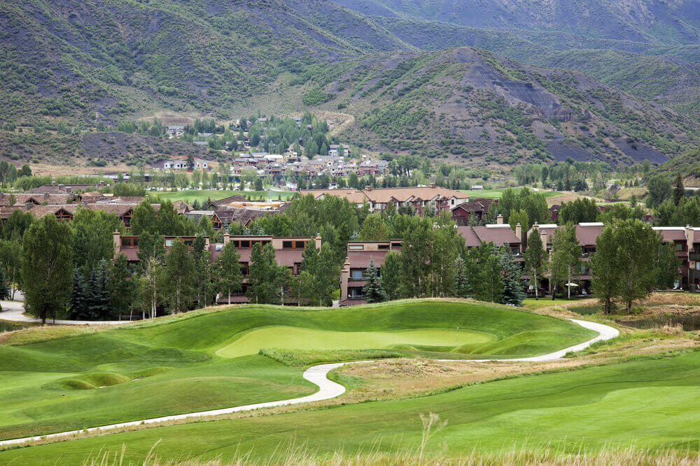 golf course with mountain lodges 