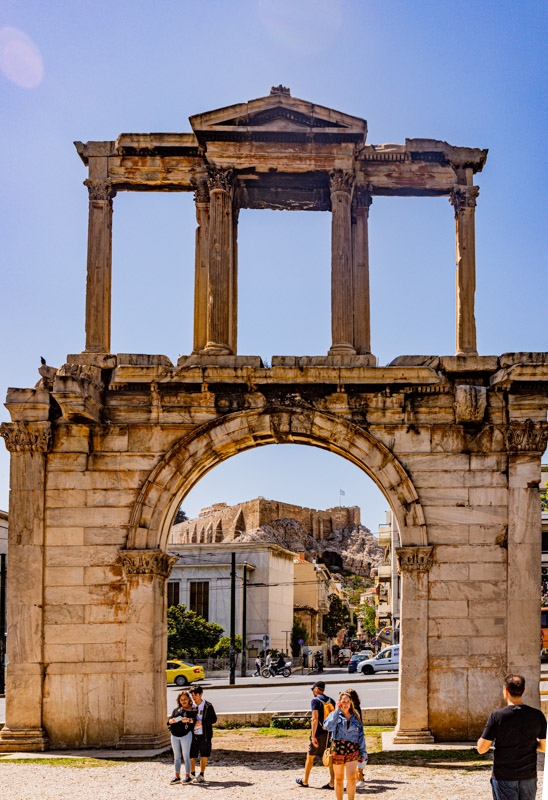 people looking up a the arch of Hadrian with view of acropolis through the arch