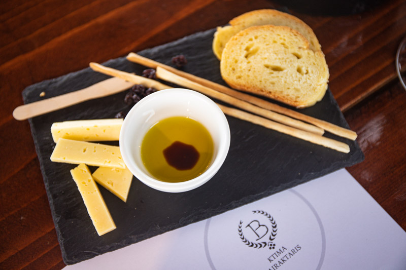 board with cheese, bread and olive oil