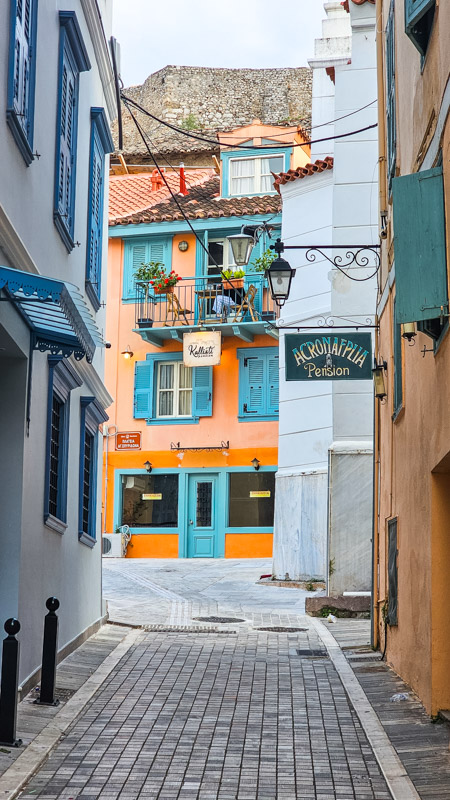 stone covered alley of nafplio with colorful buildings