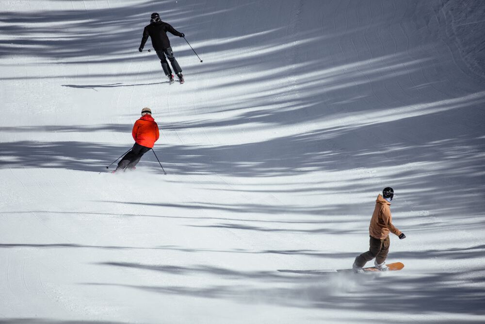 people skiiing down mountain