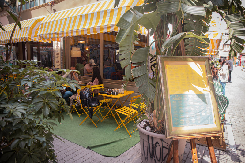 yellow tables and chairs at brunchers outside surrounded by plants
