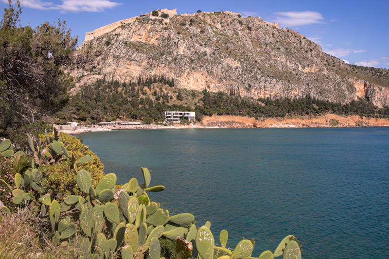 arvanitia beach with palamidi fortress above on the hill
