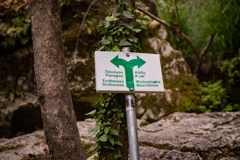 sign with arrows on trail