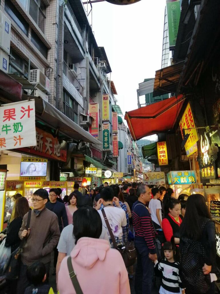 people walking through the Shilin Night Market Taipei