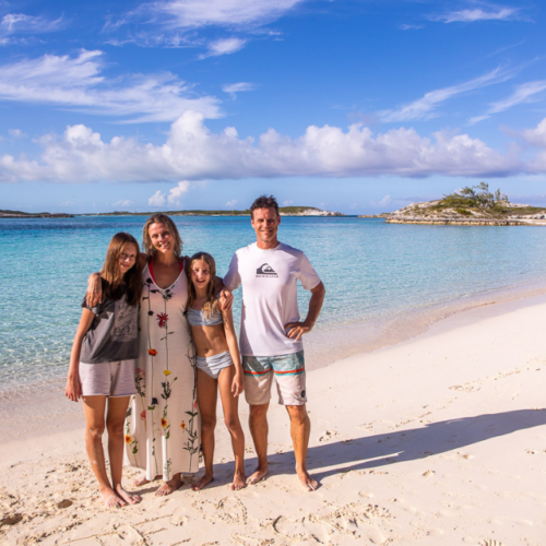 family posing on exuma island beach