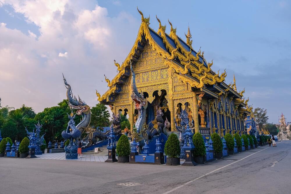 gold temple with blue roof and blue statues