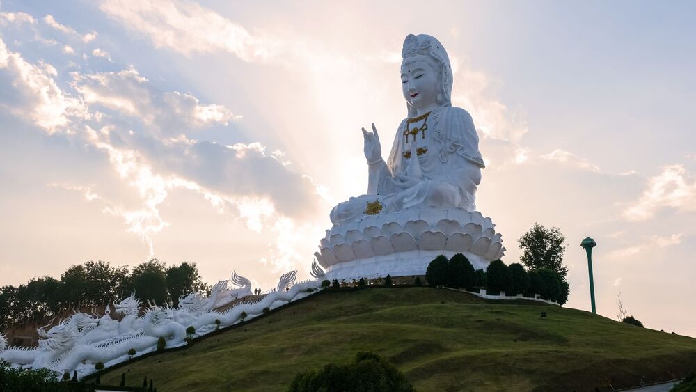 giant white buddha on hill