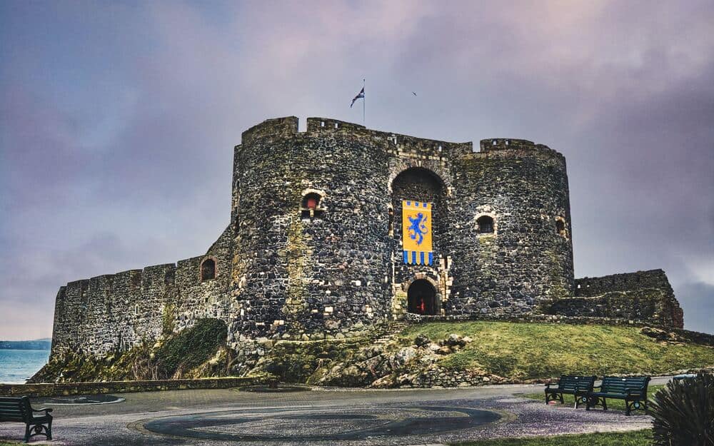 old stone grey castle with yellow banner on front