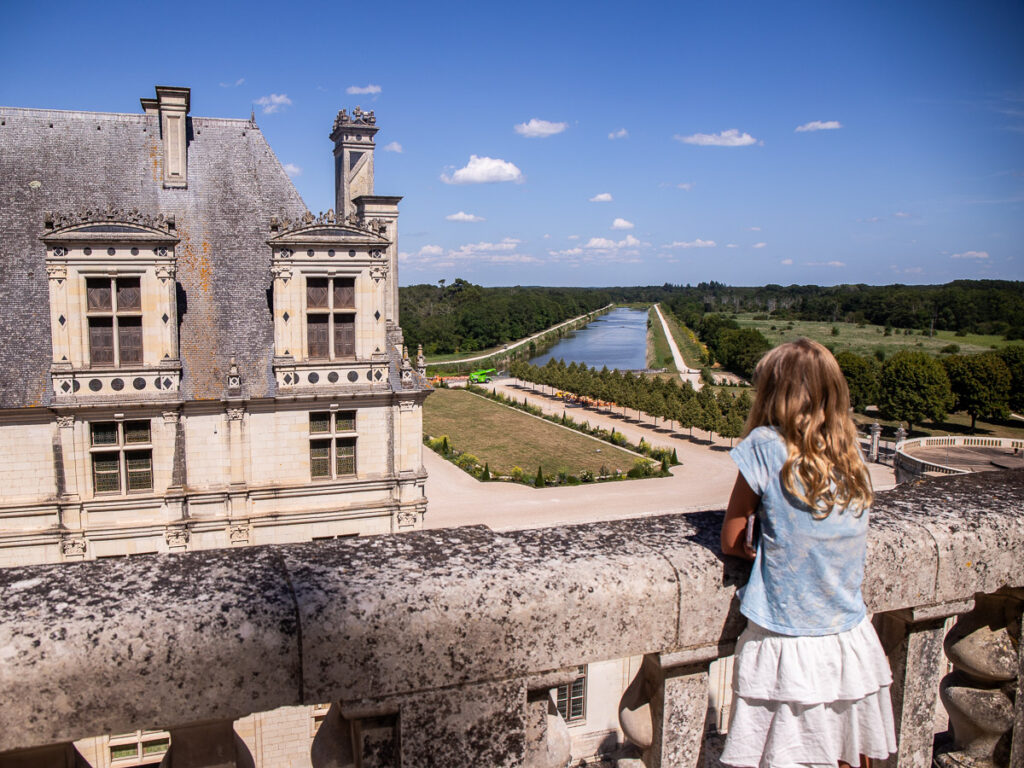 Girl leaning over a balcony of a Chateau in France
