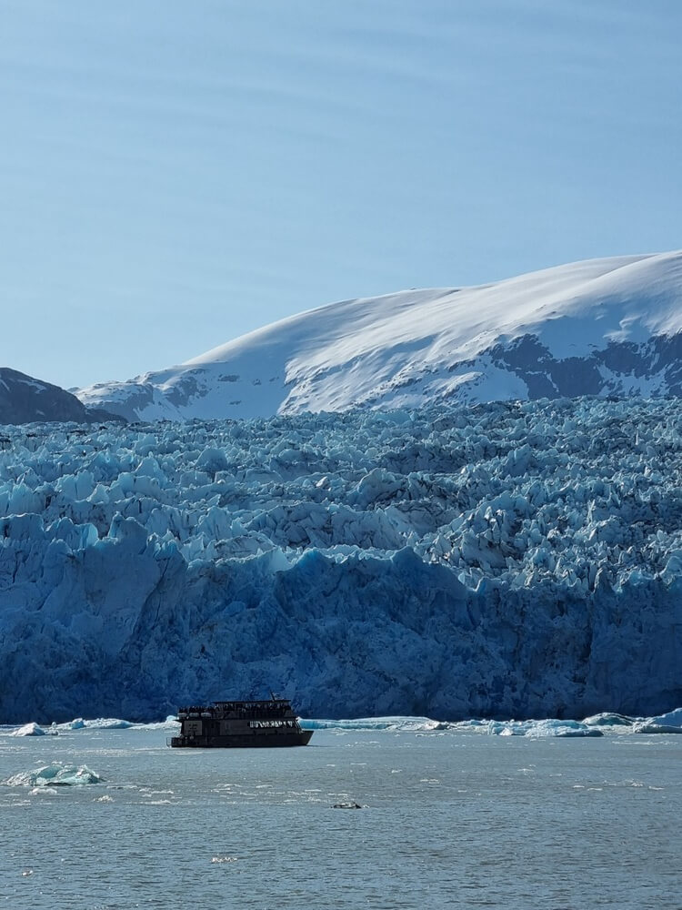 boat cruising near glacier