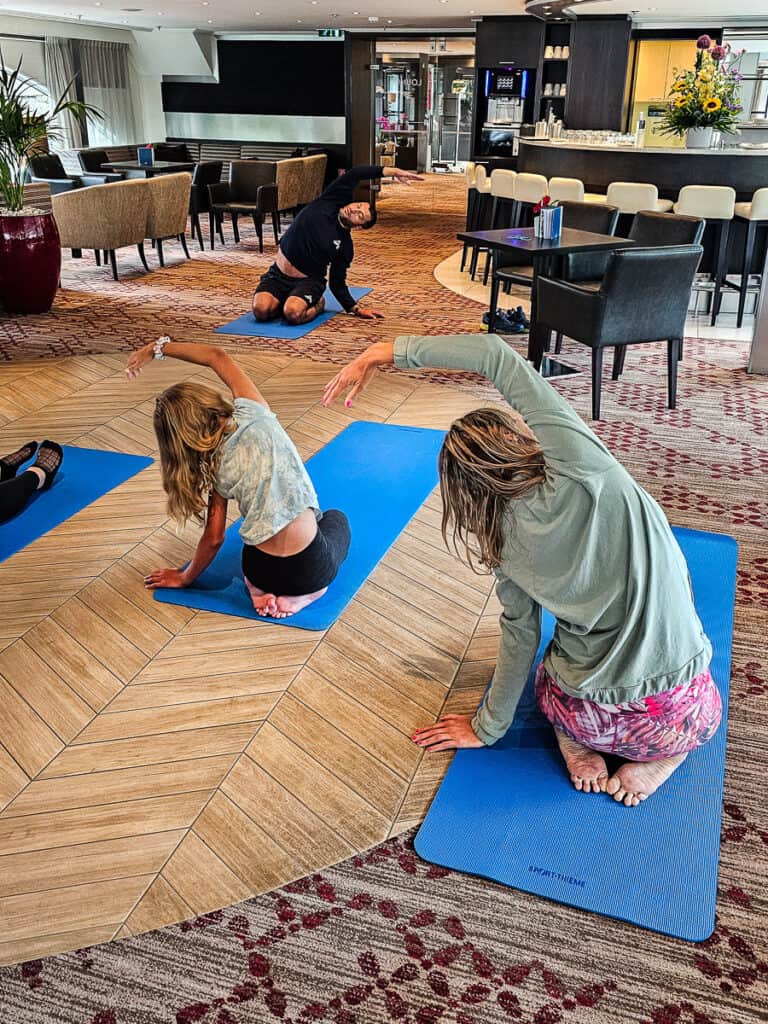 Mom and daughter doing yoga on a cruise ship