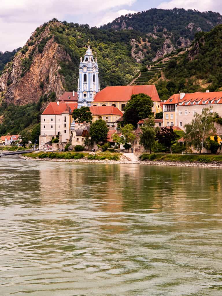 Church on the edge of a river with a mountain backdrop