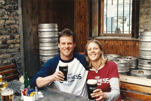 caz and craig holding pints of Guinness smiling at camera