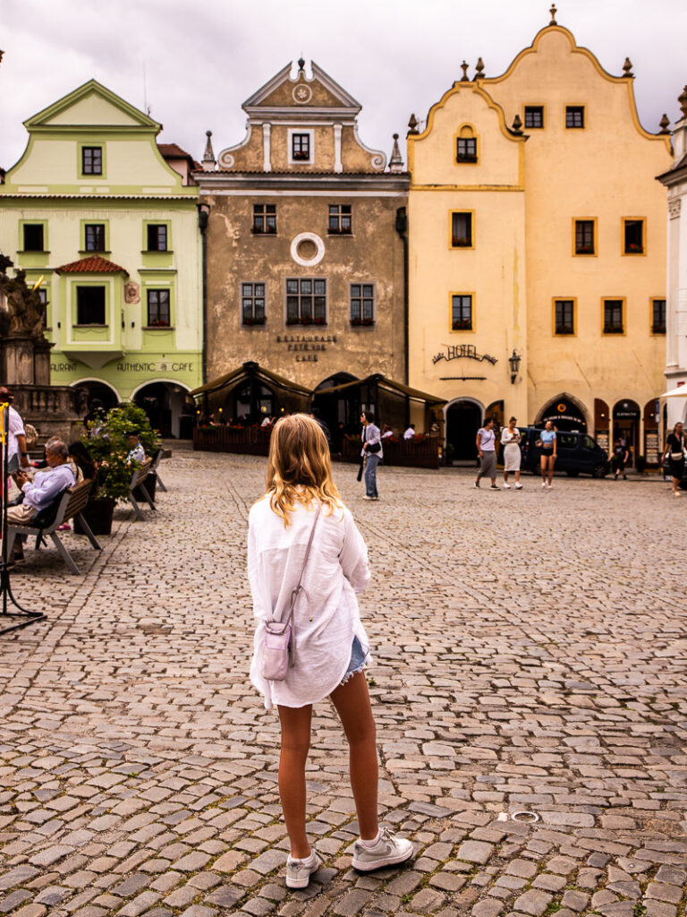Young girl standing in a city square