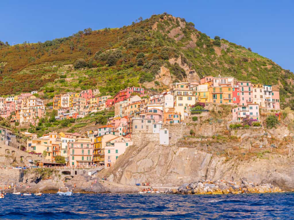 colored buildings of manarola on cliff face