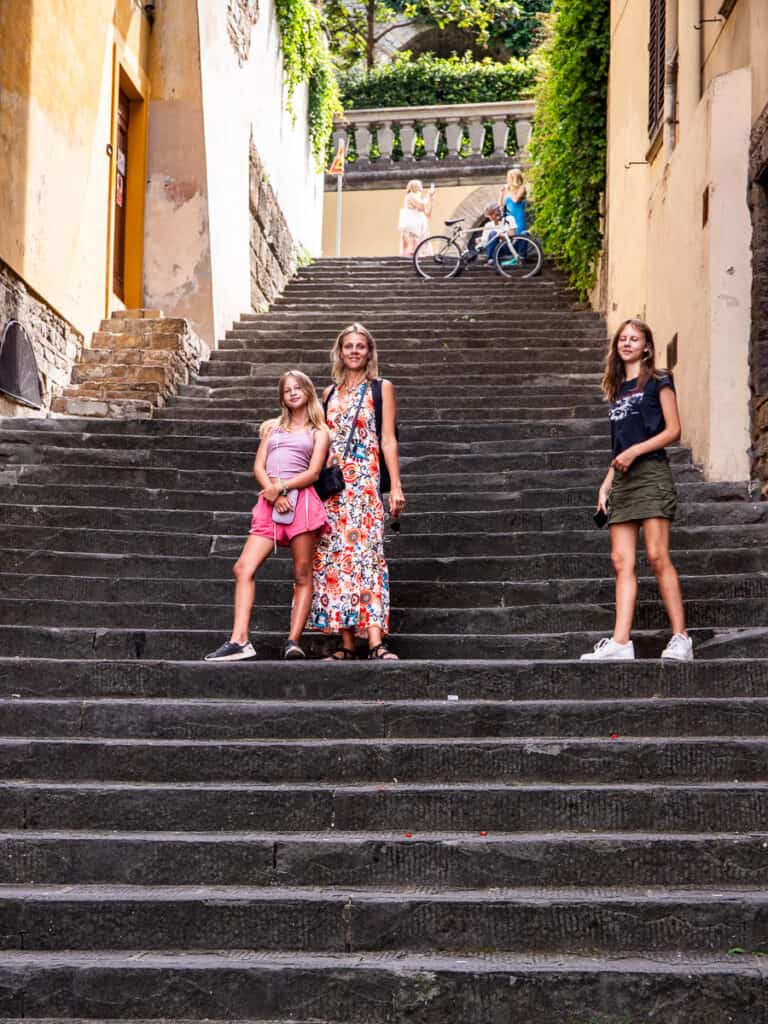 caz and girls posing on stairs in oltrarno florence
